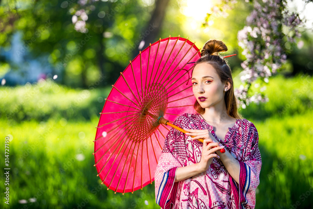 穿着和服，带着雨伞的日本女人。美丽的亚洲女孩，用绿色的sce化妆