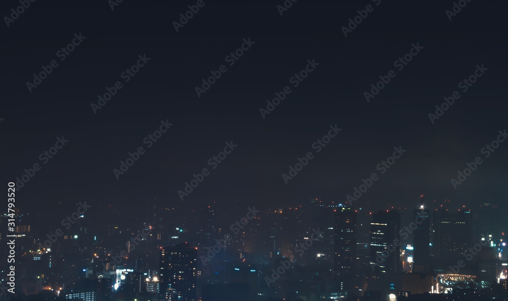 Aerial view of a storm passing over the Osaka skyline at night