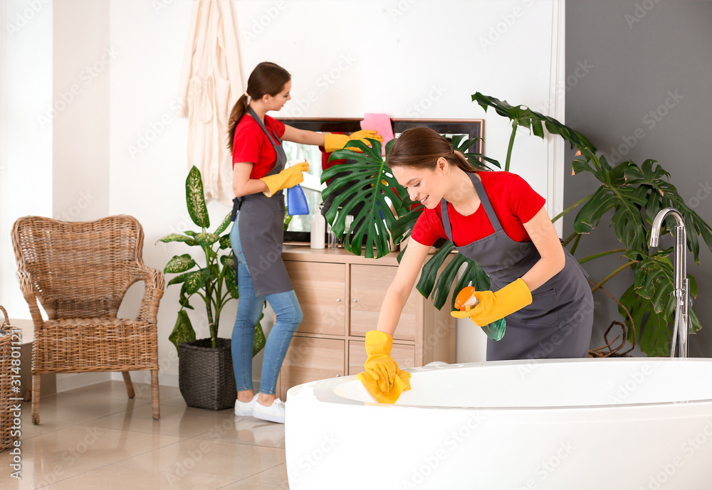 Team of janitors cleaning bathroom