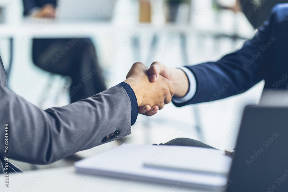 Business people shaking hands at the office. Success teamwork, partnership and handshake business co