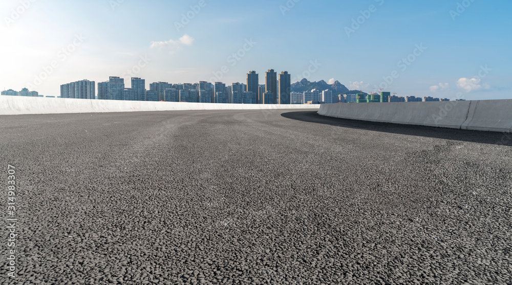 Road surface and urban architectural landscape skyline