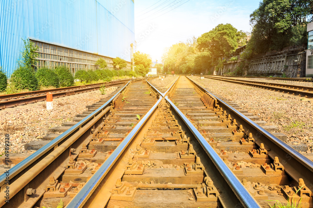 Railway passing through industrial area plant building.