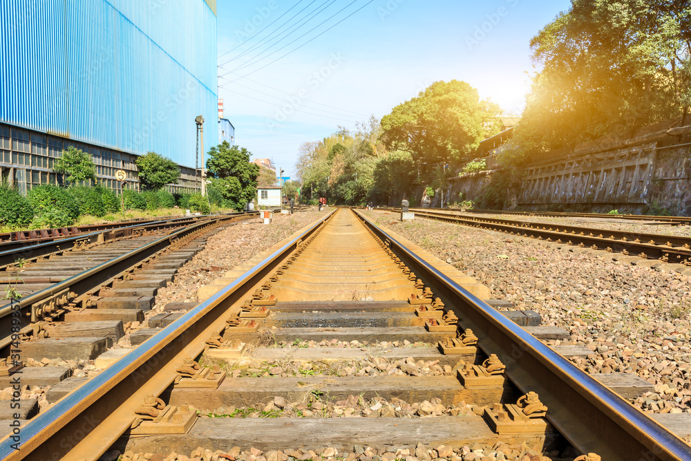 Railway passing through industrial area plant building.