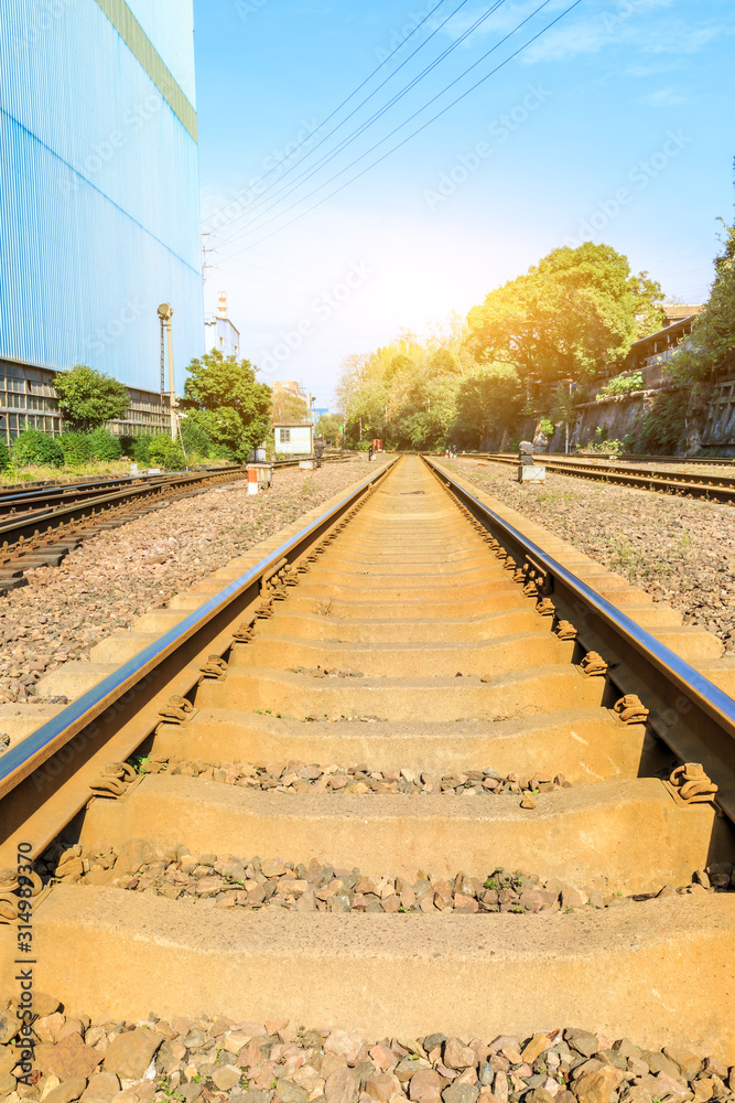 Railway passing through industrial area plant building.