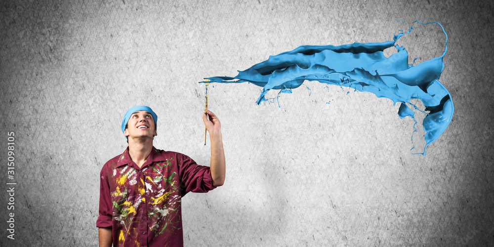 Young artist painting blue brush stroke