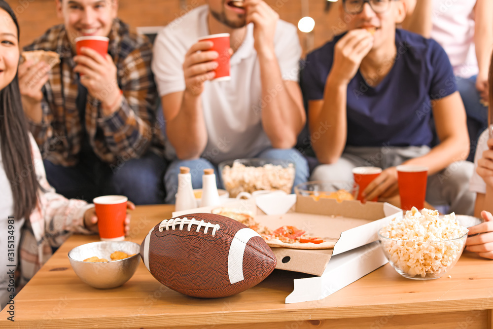 Group of fans watching rugby on TV