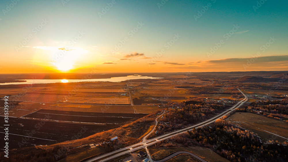 sunset over luskville and ottawa river city in quebec