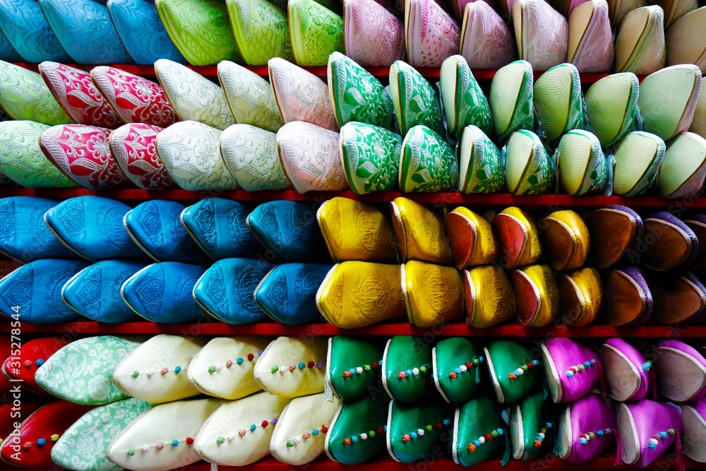 assortment of colorful moroccan babouche- slippers shoes-sold in market in the médina of marrakech 