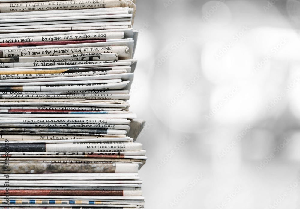 Pile of newspapers on a bokeh background