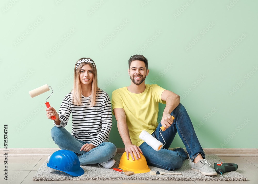 Happy young couple resting during repair in their new house