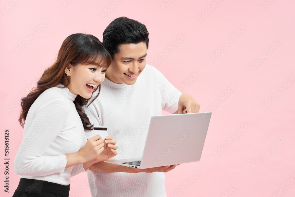 So easy! Excited happy couple doing online shopping in internet.