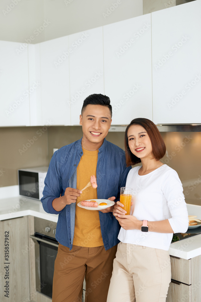 Couple cooking together in the kitchen at home