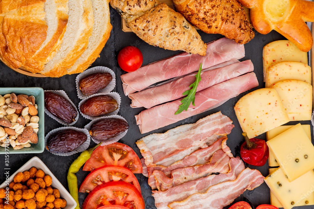 Breakfast on the table. Croissant bread, Croissant cereal, Bacon, ham, cheese, lettuce, beans, corn 