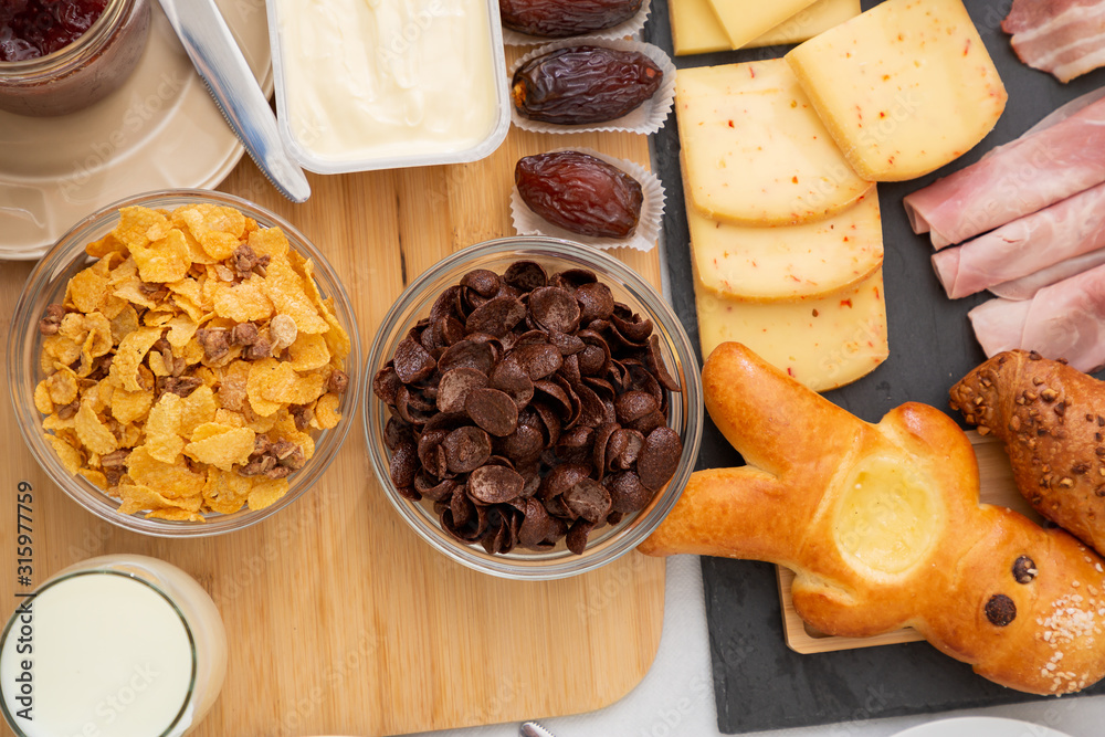 Breakfast on the table. Croissant bread, Croissant cereal, Bacon, ham, cheese, lettuce, beans, corn 