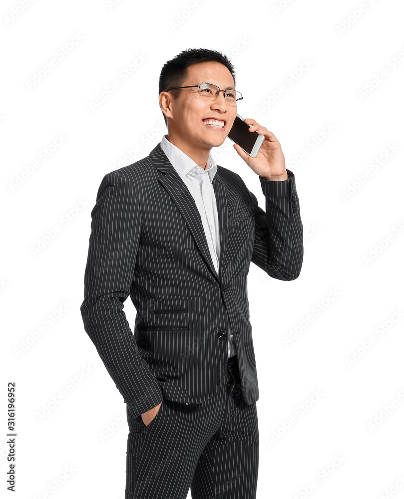 Portrait of Asian businessman talking by phone on white background