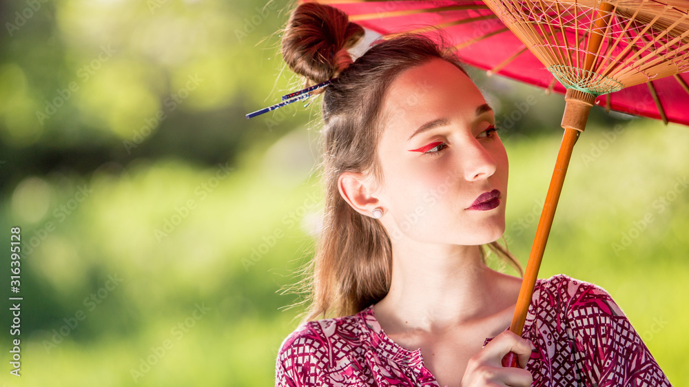 Japanese woman in kimono and with umbrella