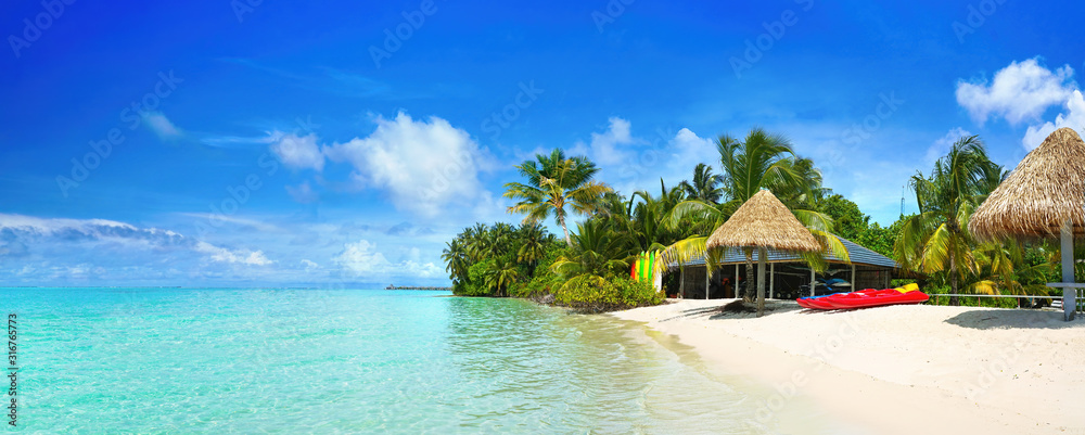 Beautiful beach with white sand, turquoise ocean and blue sky with clouds on Sunny day. Summer tropi