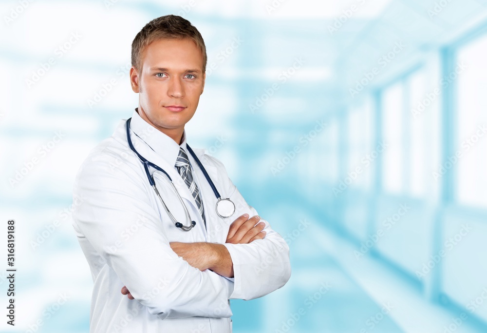 Young doctor portrait at blurred hospital background