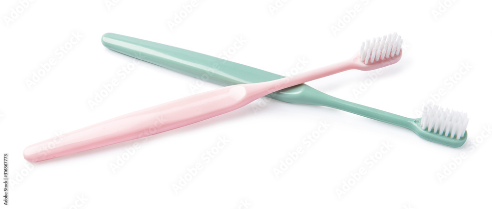 Different tooth brushes on white background