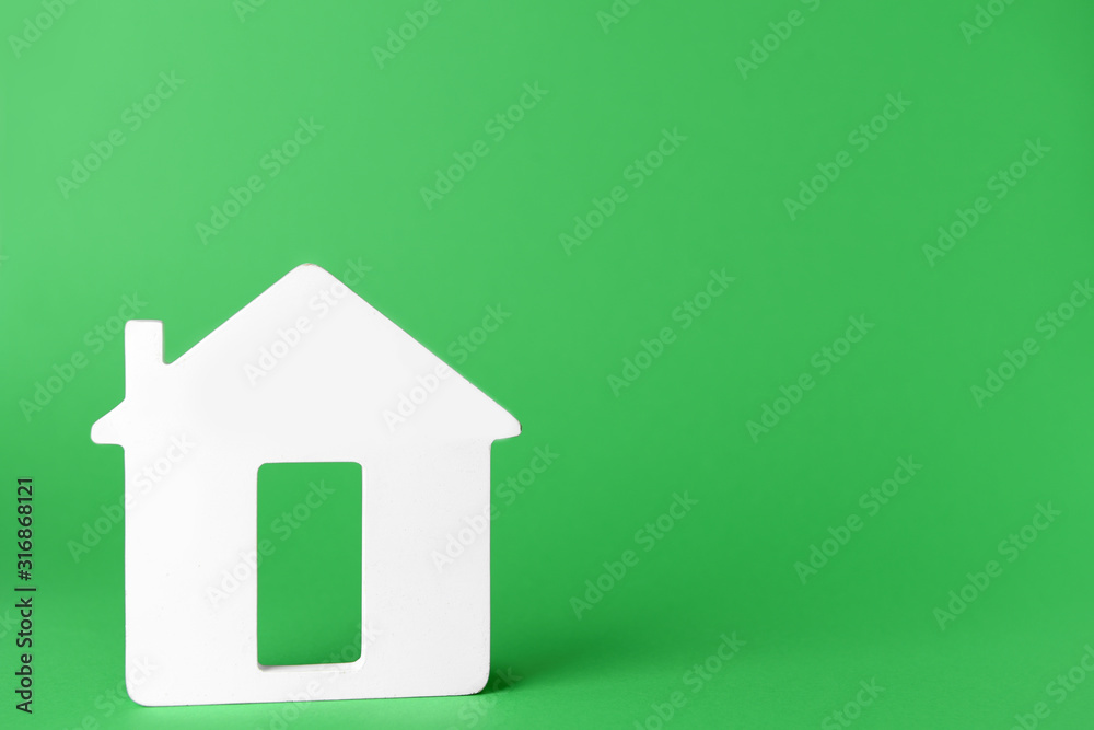 Figure of house on color background. Concept of buying real estate