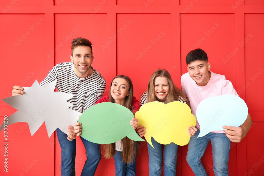 Group of young people with blank speech bubbles on color background