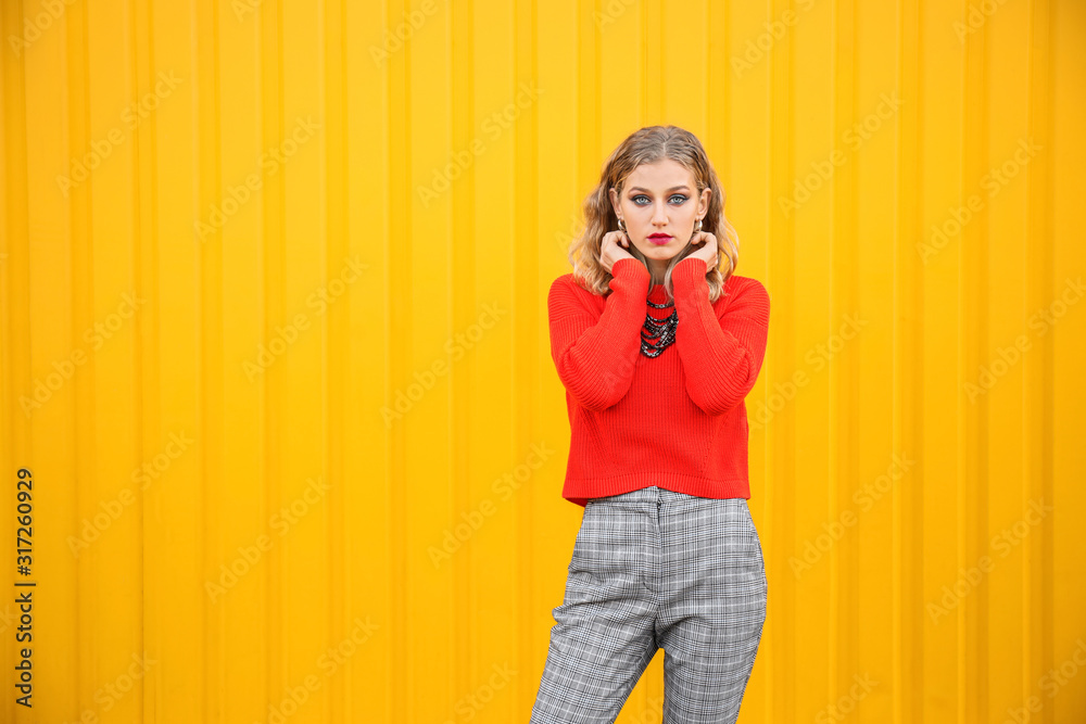 Portrait of fashionable young woman on color background