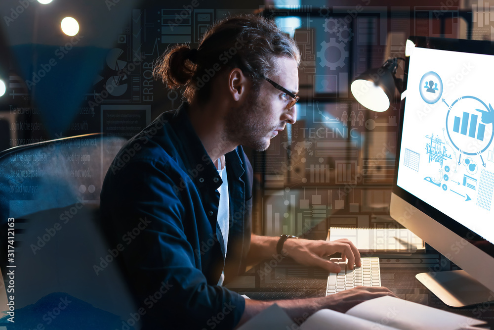 Man trying to meet deadline in office late in evening