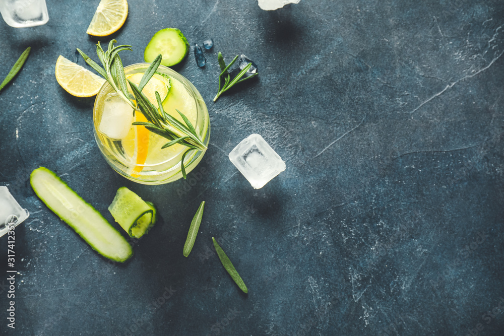 Glass of healthy infused water and ice cubes on table