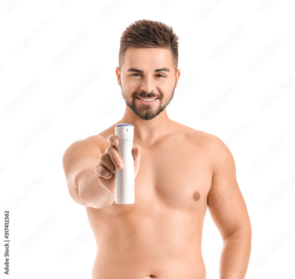 Handsome young man with deodorant on white background