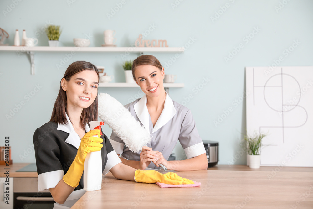 Portrait of beautiful young chambermaids in kitchen