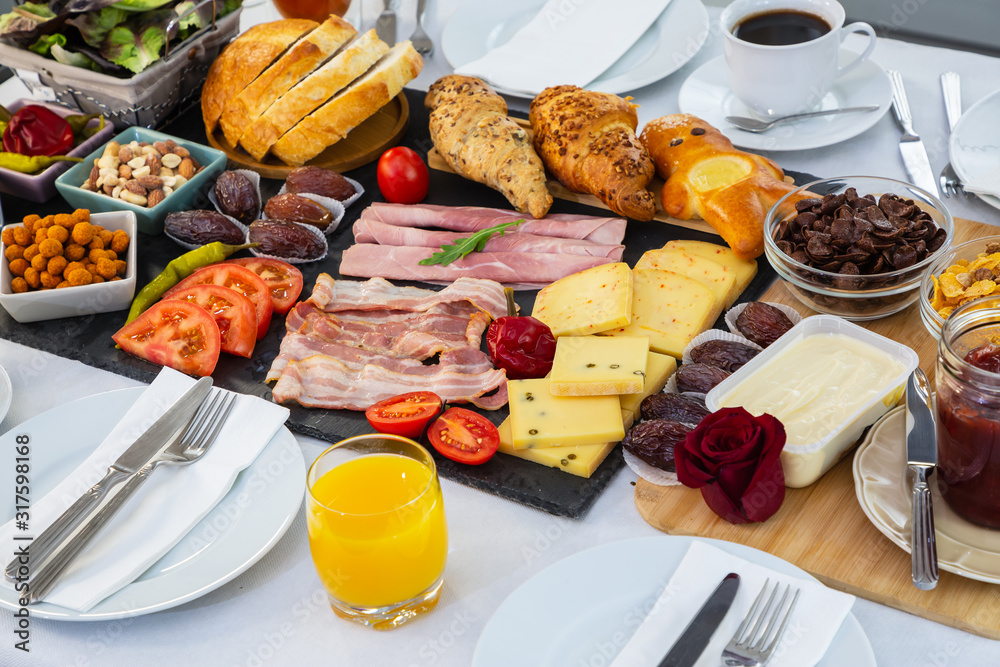 Breakfast on the table. Croissant bread, Croissant cereal, Bacon, ham, cheese, lettuce, beans, corn 