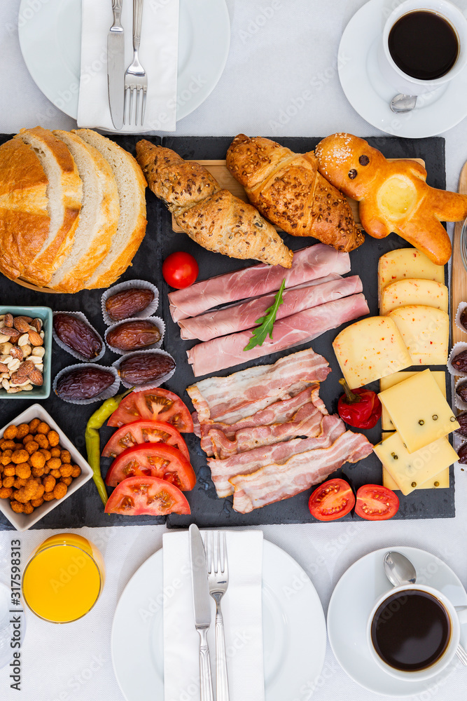 Breakfast on the table. Croissant bread, Croissant cereal, Bacon, ham, cheese, lettuce, beans, corn 