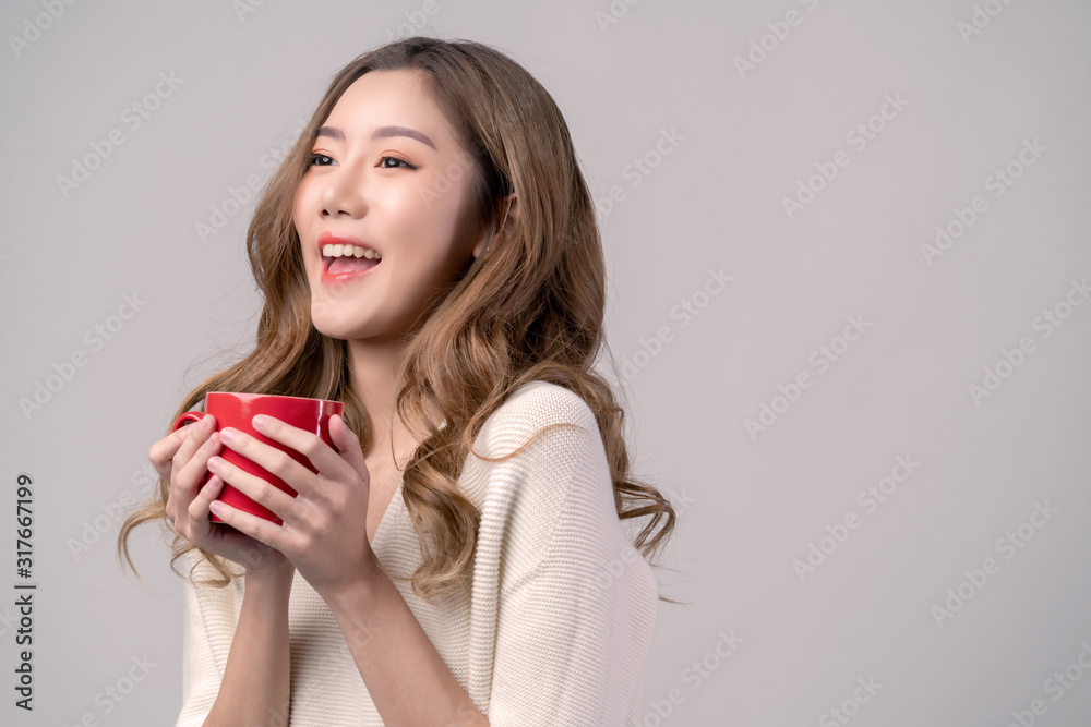 attractive asian beautiful female woman hand hold hot cup coffee drink look at camera portrait studi