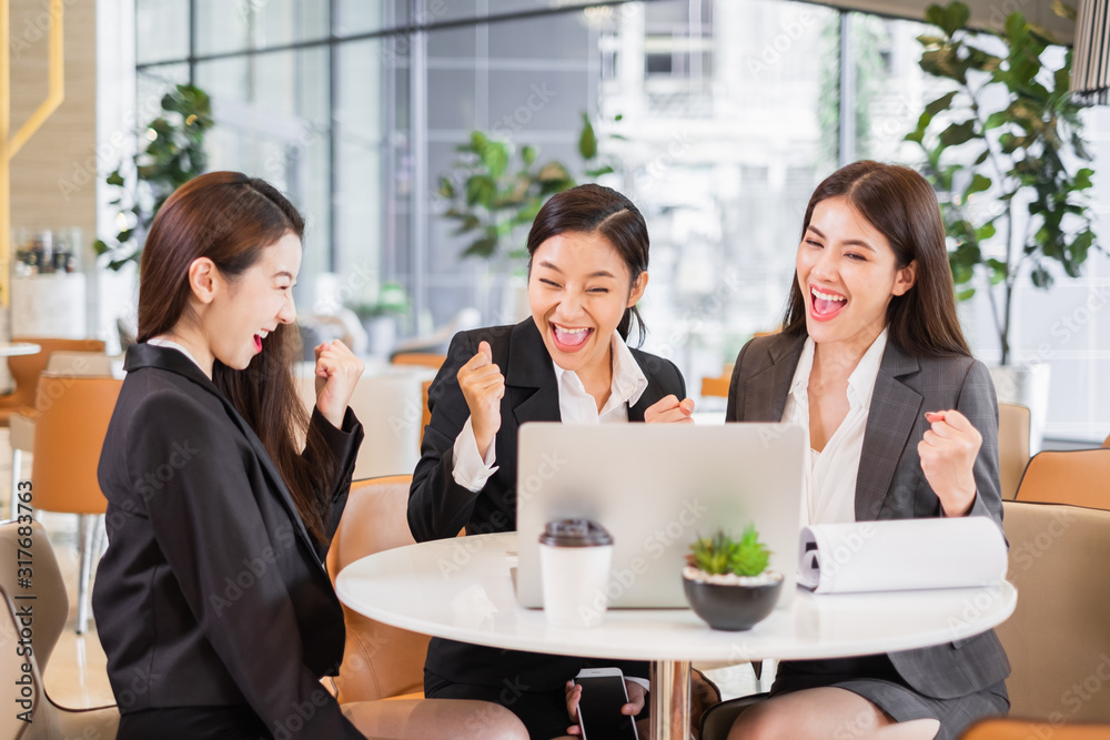 Group of Asian business looking at laptop mornitor feel happy and success in office