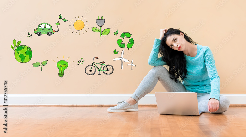 Eco theme with young woman using a laptop computer