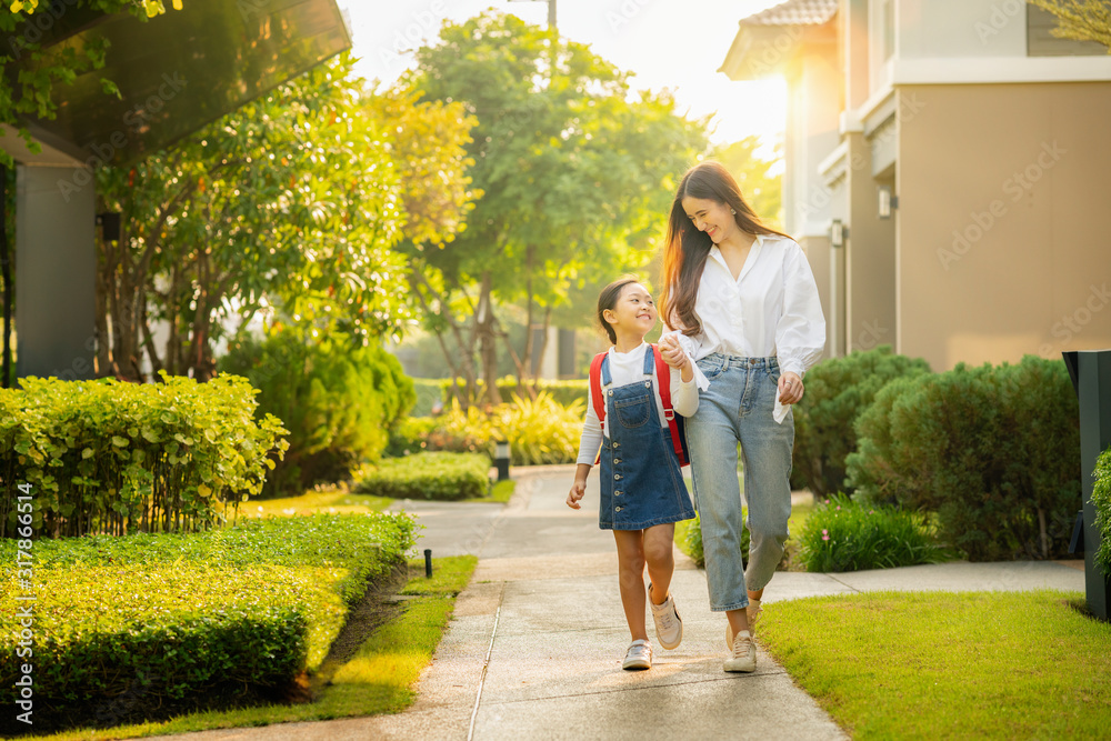 Asian preschool girl walk with her mother to go to school