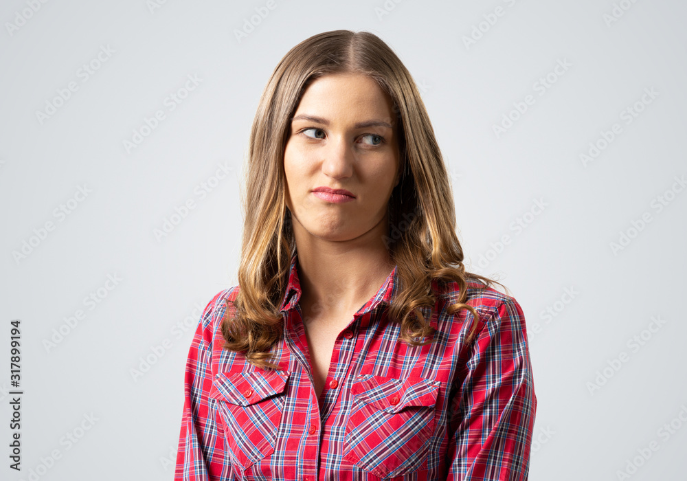 Distrustful brown haired woman looks suspiciously