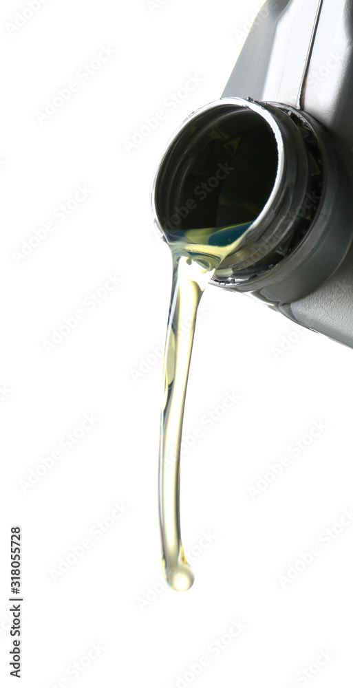 Pouring of car oil from canister against white background