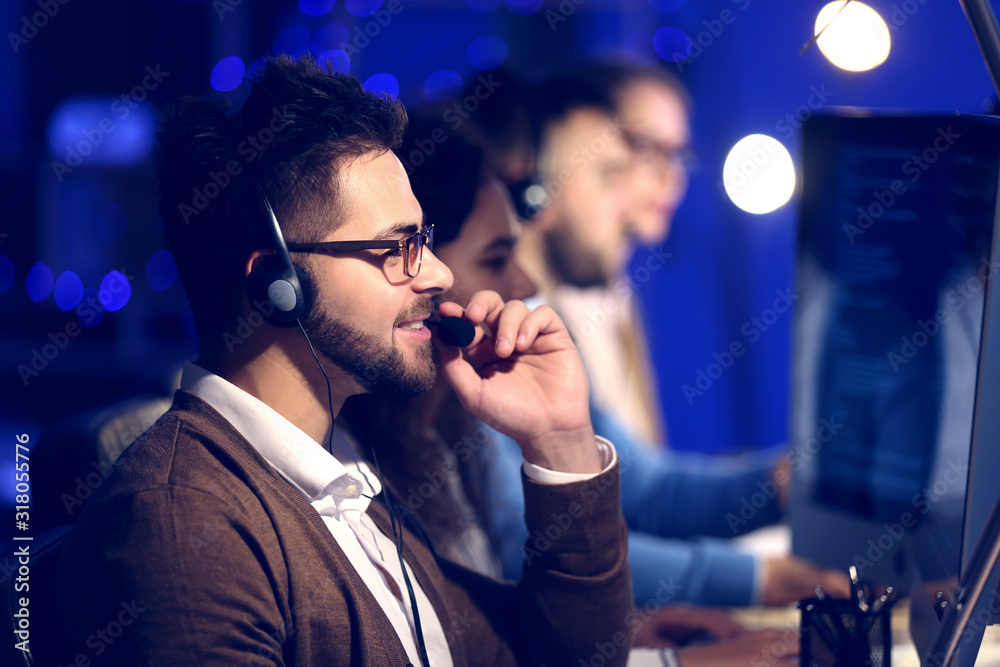 Technical support agents working in office at night