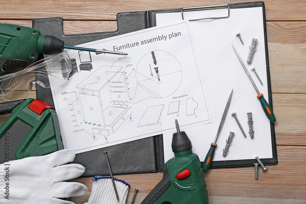 Furniture assembling plan with set of tools on table