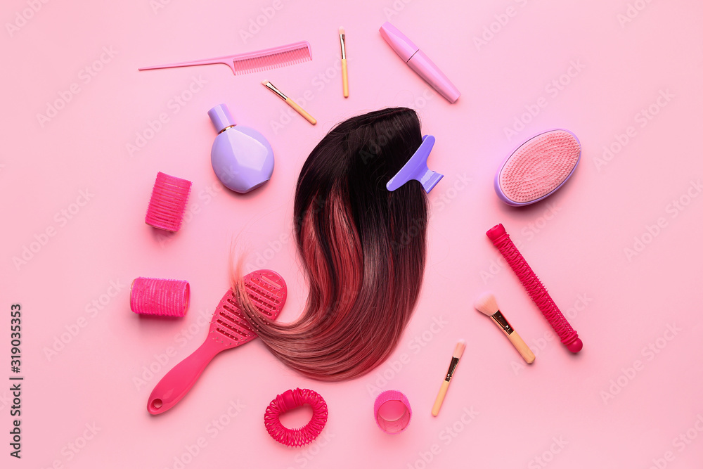 Composition with hair strand and different tools on color background