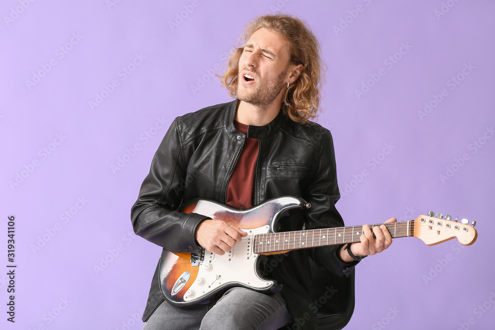 Man playing guitar and singing on color background