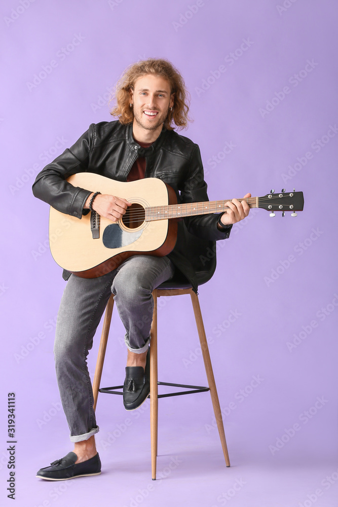 Man playing guitar on color background