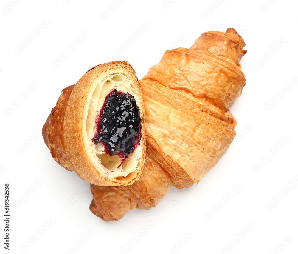 Tasty sweet croissants on white background