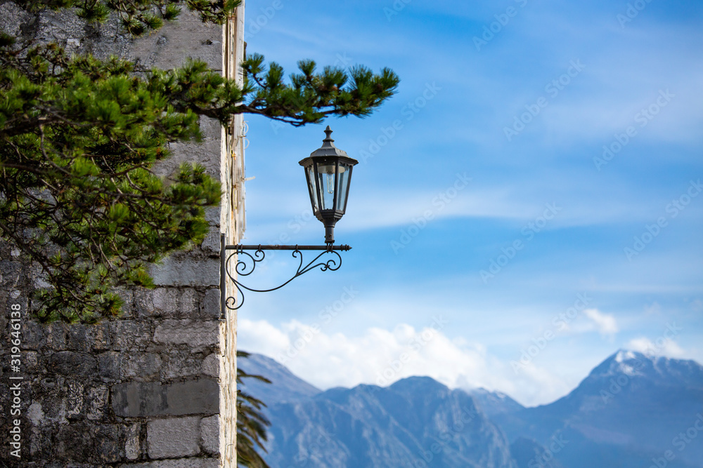 Mountain peaks on the horizon. Stone wall of an old building. Copy space on the right.