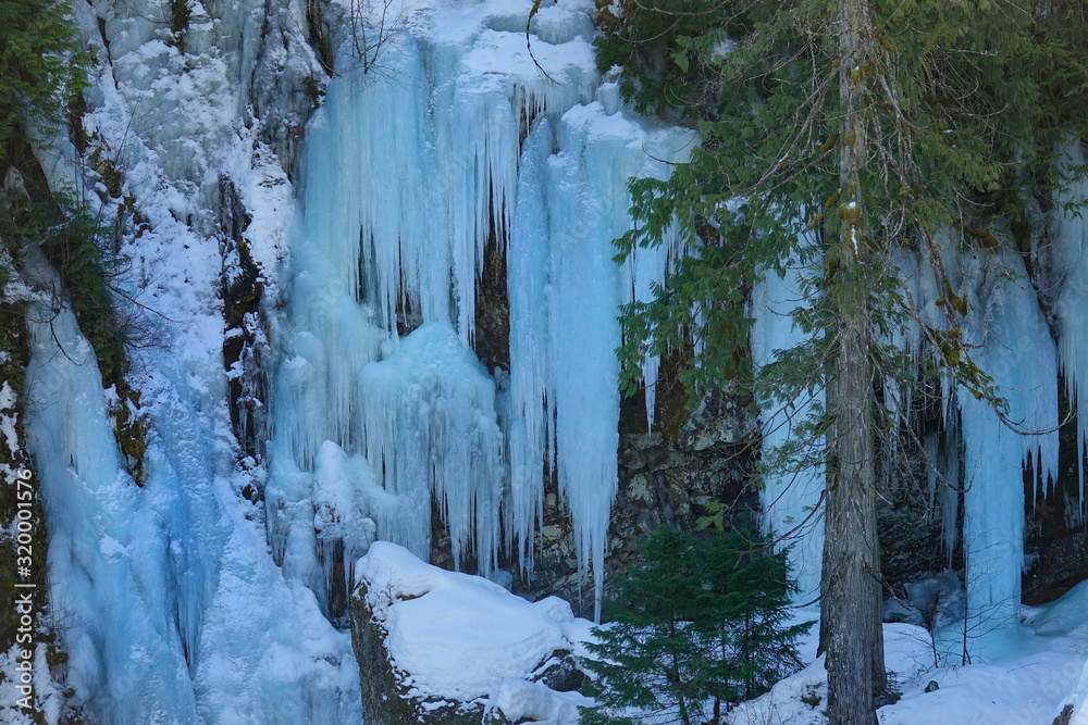 CLOSE UP: Waterfall freezing in the winter cold creates beautiful icicles.