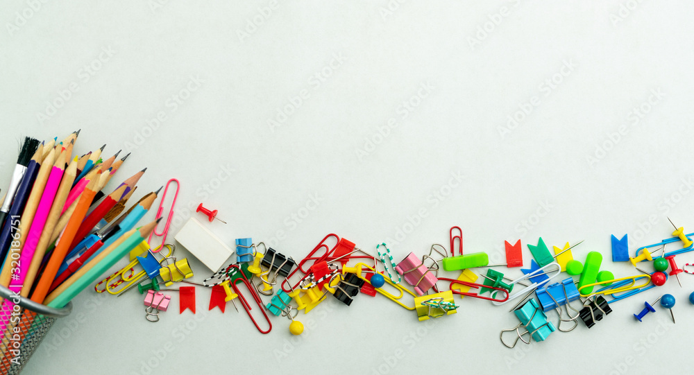 Set of colorful colored push pins Thumbtacks and pencil top view isolated on white background.