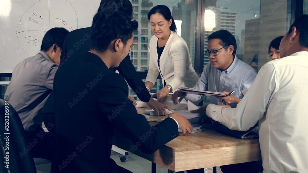 Asian business people discuss marketing strategy in group meeting at modern office. Business finance