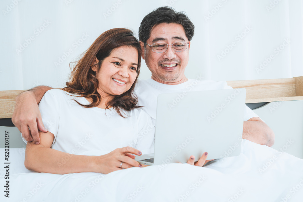 Happy Asian senior couple having good time at home. Old people retirement and healthy citizens elder