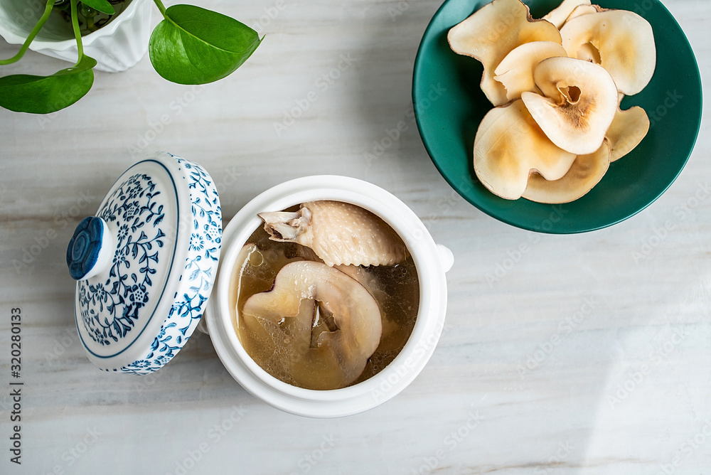 Chinese health tonic soup, stewed chicken soup with ring snails